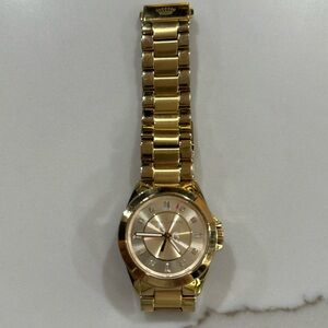 Juicy Couture gold watch.
